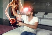 77859337-young-casual-man-playing-on-vr-device-with-fiery-virtual-woman-silhouette-indoors.jpg